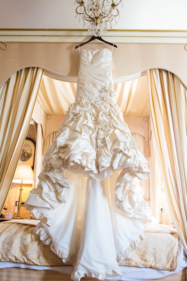 Cream ruffle wedding dress hanging