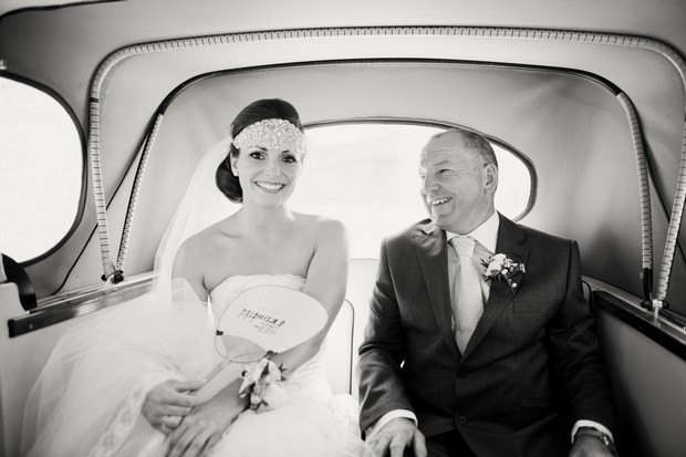 bride and father of the bride in car black and white
