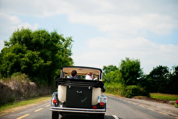 bride and groom driving getaway car