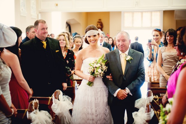 bride walking up aisle with father