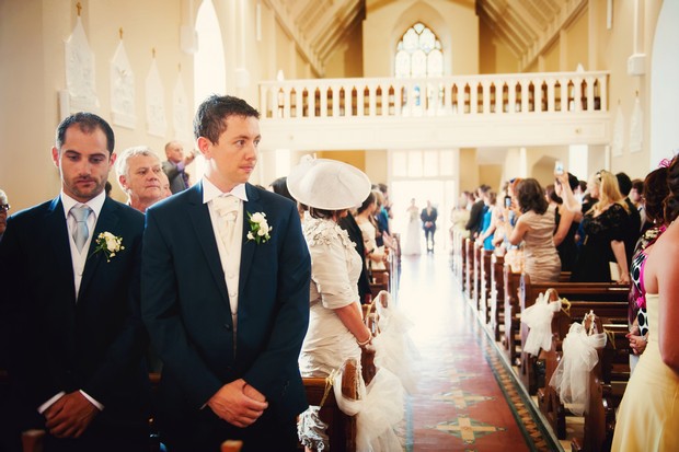 groom waiting for bride at alter entrance