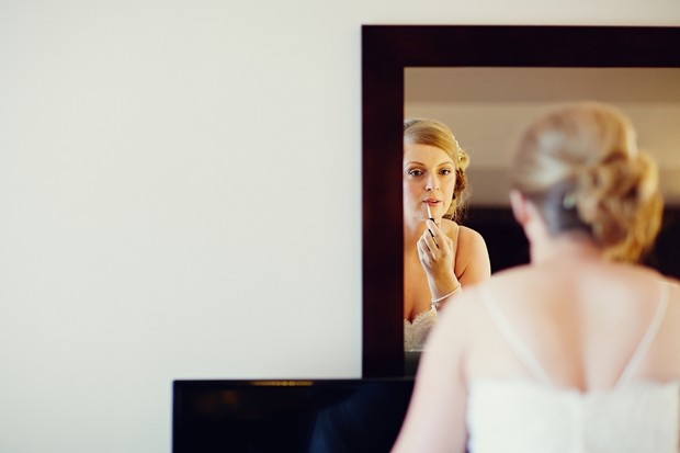 bride-in-mirror-doing-make-up