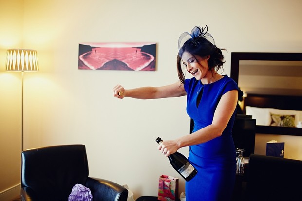bridesmaid-opening-champagne-getting-ready