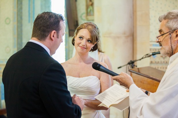 bride and groom exchange vows in chruch
