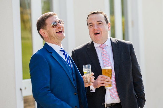 wedding guests laughing in the sun