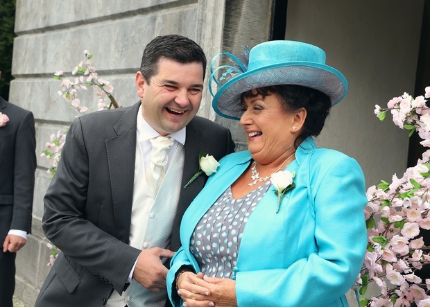 groom and mother laughing outside church