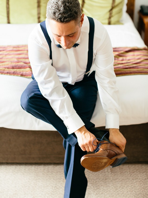 groom getting ready brown shoes navy suit