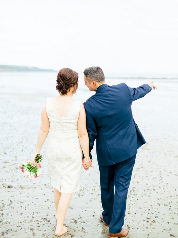 bride groom walking on beach hand