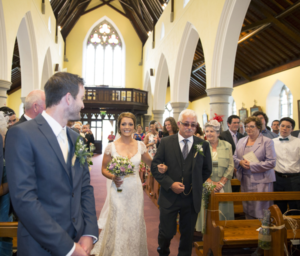 bride father walking up aisle church