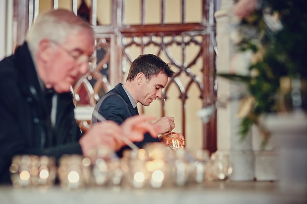 17-groomsmen-lighting-candles-wedding-church