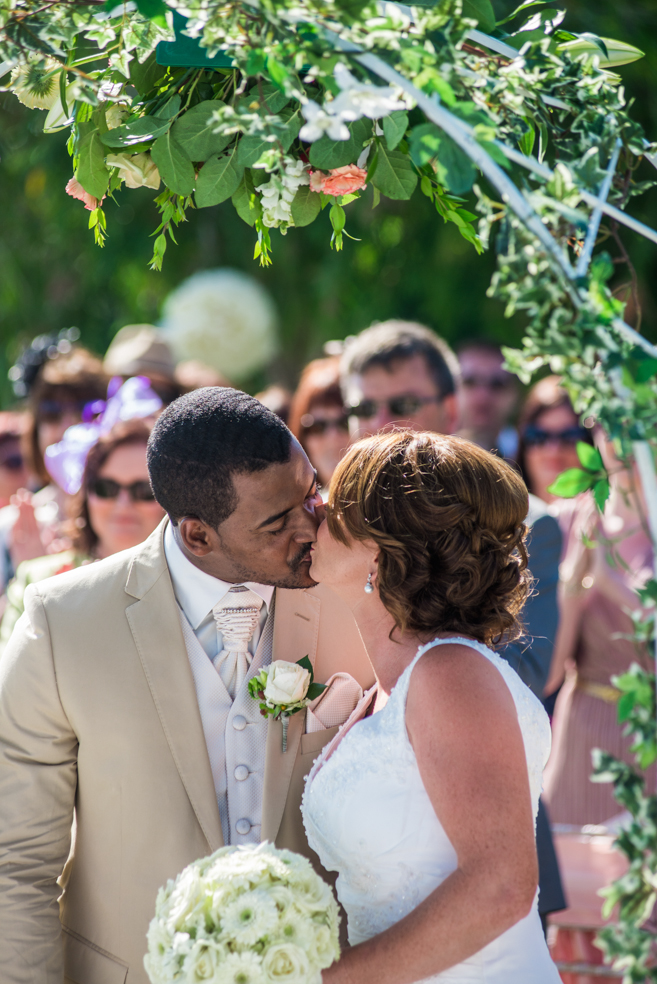 bride groom kissing garden wedding ceremony