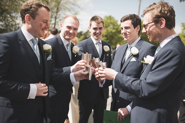 groomsmen-toasting-wedding-with-hip-flasks