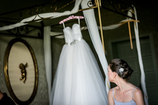 4-Bride-admiring-wedding-dress-bridal-suite