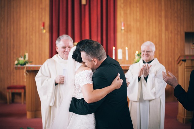 bride-and-groom-hugging-church-wedding-ceremony