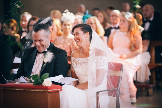 bride-and-groom-laughing-church-wedding-ceremony