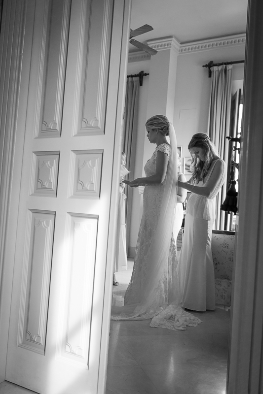 7-bridesmaid-helping-bride-getting-ready-dress-fitting-Owen-Farrell-Photography