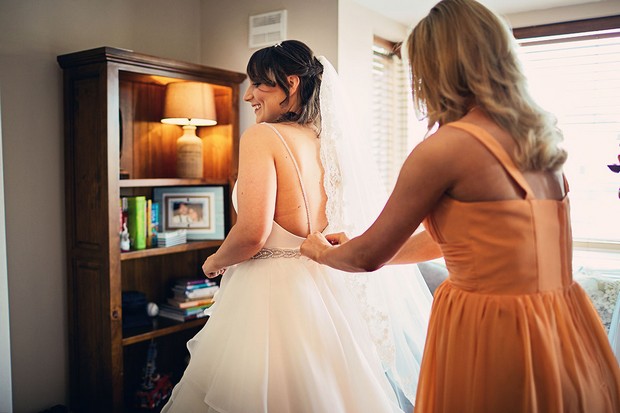 15-bride-getting-ready-dress-fitting-bridesmaid-weddingsonline