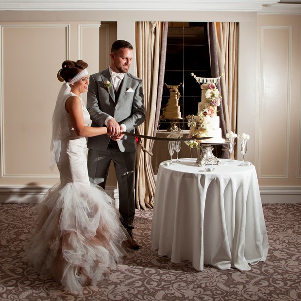 bellingham-castle-real-wedding-bride-groom-cutting-the-cake