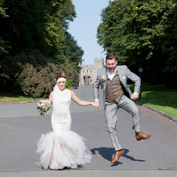 bellingham-castle-real-wedding-groom-jumping