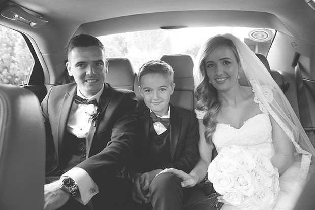 bride-and-groom-in-getaway-car-with-page-boy