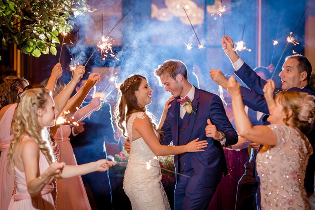 bride-and-groom-surrounded-by-guests-with-sparklers