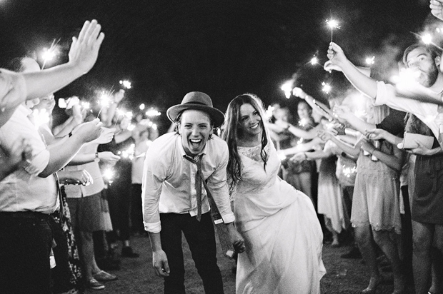 couple-surrounded-by-sparklers-wedding-entrance