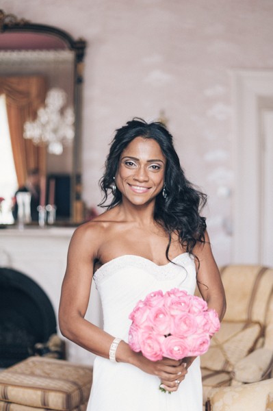 bride with casual hair and pink bouquet