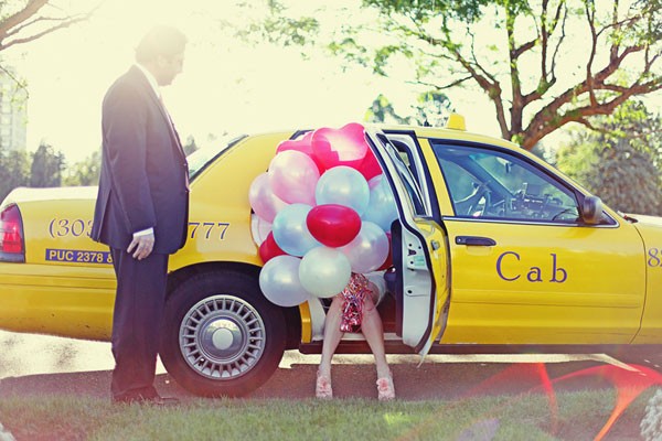bride in car with balloon bouquet