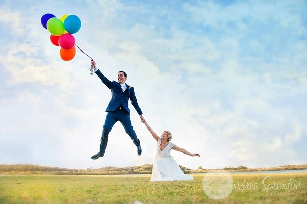 groom flying away with balloons bride holding on