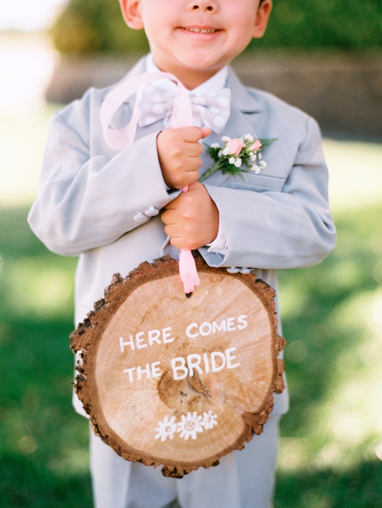 cute-page-boy-signs-here-comes-the-bride-rustic